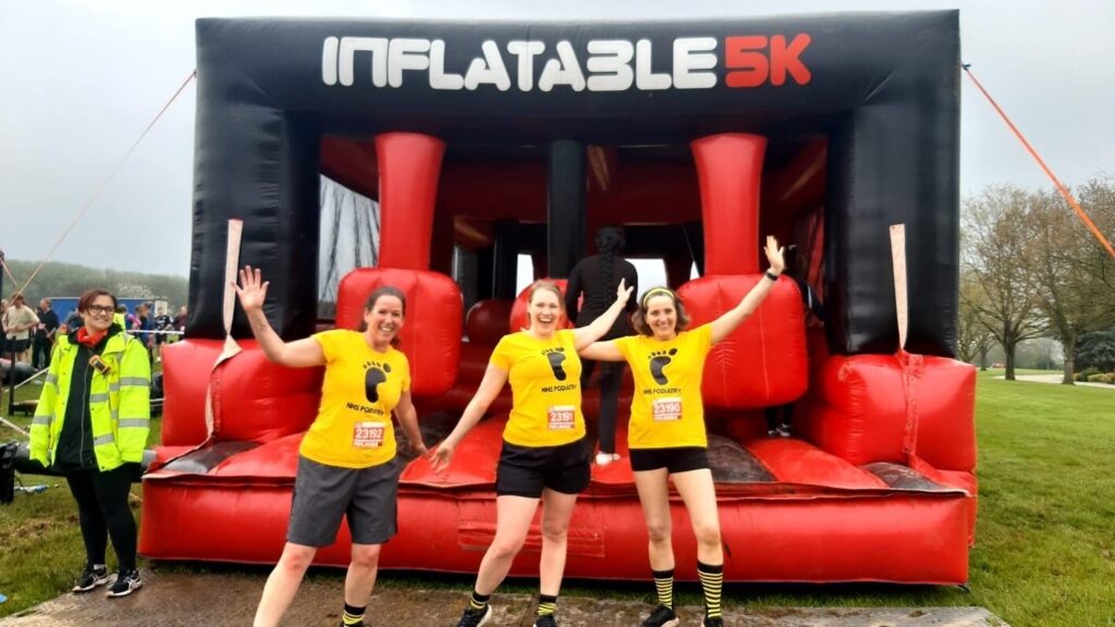 Participants cheering in front of one if the Inflatable 5k obstacles 